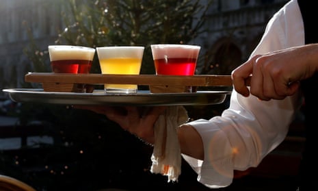 A waiter in Brussels carries glasses of Belgian beer