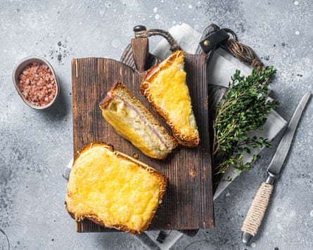 Above view of French croque Monsieur sandwich with Cheese, Ham, Gruyere and Bechamel Sauce. Gray background.
