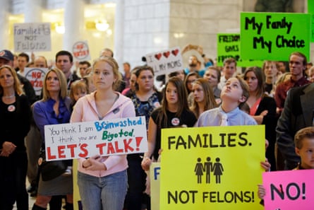 Polygamy advocate Hannah Willams, left, joins others gathering at the Utah state capitol to protest a proposal that would make polygamy a felony crime in 2016.