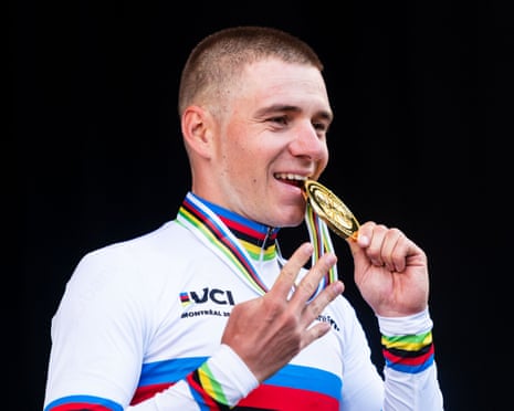 Remco Evenepoel bites his gold medal after winning the men's individual time trial.