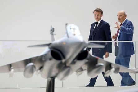 Emmanuel Macron (left) and Eric Trappier looking at a display model of a Rafale fighter jet at the 55th International Paris air show in June 2025.