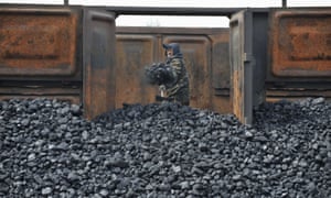A worker unloads coal at a storage site in Shenyang, China. The report by coal industry executives claims coal is not the cause of China’s air quality problem. 