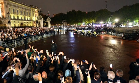 Crowds waited in the rain outside Buckingham Palace to watch the Queen’s hearse arrive.