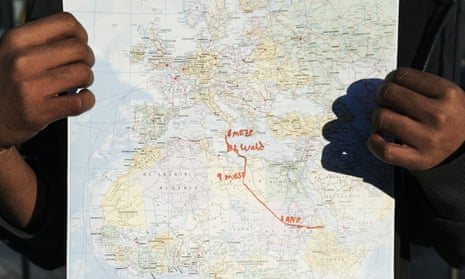 Abrahm from Eritrea, who is 17 years old, holds up a map showing his route to Italy