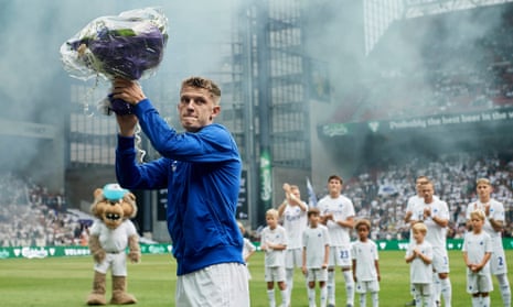 Jens Stage accepts a bouquet of flowers prior to the Danish Superliga match between FC Copenhagen and AGF Aarhus on 19 July, five days after Stage’s flat was set on fire