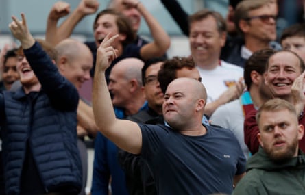 West Ham fans gesture towards the Spurs fans after Cheikhou Kouyate scores their second goal