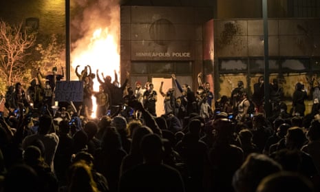 Protesters gesture after the Minneapolis police 3rd Precinct building was set on fire on Thursday night