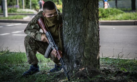A pro-Russia militiaman taking cover as Ukrainian troops attack rebels at Donetsk international airport. 