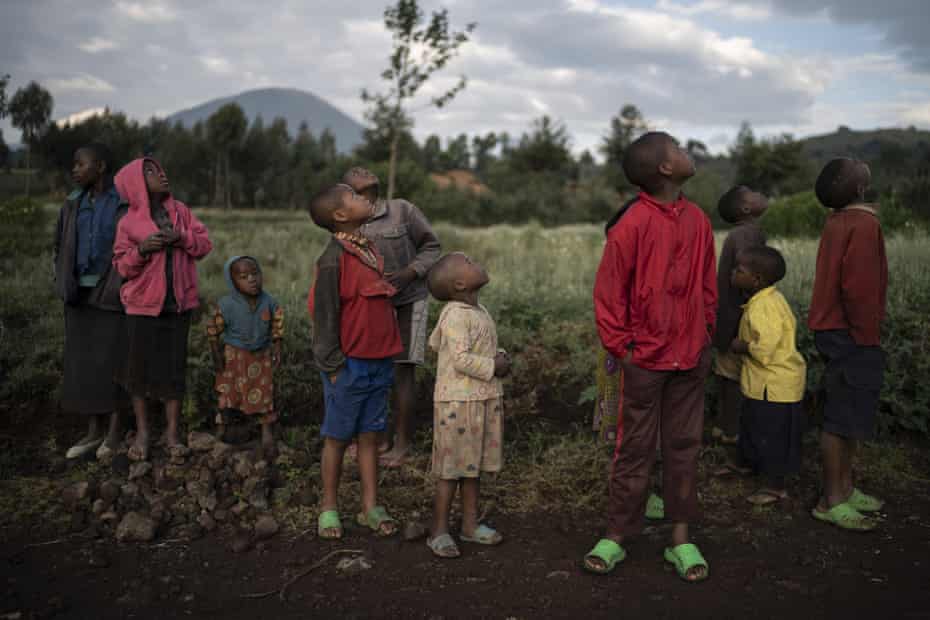 Children watch a drone flying near the Volcanoes national park in Kinigi, Rwanda.