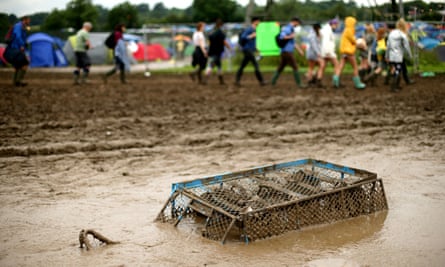 A trolley submerged in mud at Glastonbury 2016.