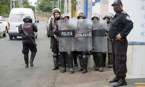 Police officers keep watch outside the attorney general’s office where Félix Maradiaga, an aspiring opposition candidate, was summoned by authorities, in Managua, Nicaragua, last week.