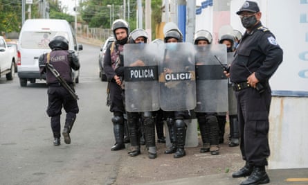 Police officers keep watch outside the Nicaragua Attorney General of the Republic office where Felix Maradiaga, an aspiring opposition candidate, was summoned by authorities.