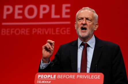 Corbyn speaking on stage during a Labour conference