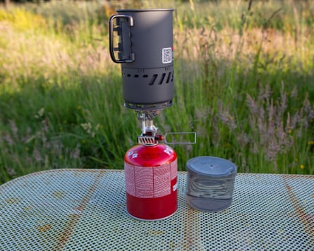 The MSR Switch System Stove on a metal table in a field