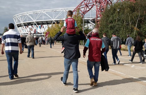 Three generations of West Ham fans arrive at the London Stadium for the West Ham United v Tottenham Hotspur match.