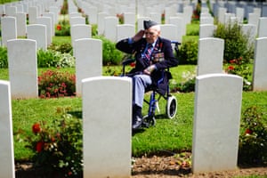 RAF veteran Bernard Morgan, 100, in a wheelchair salutes the war graves