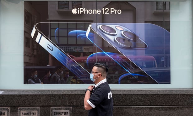Man walks past add for the iPhone 12 in Hong Kong