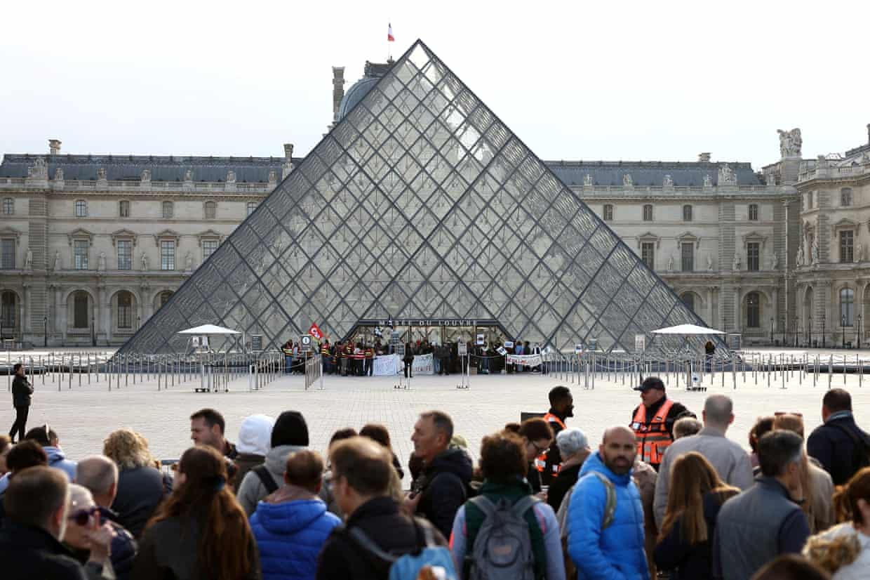 Protesters outside the entrance of the Louvre Museum.