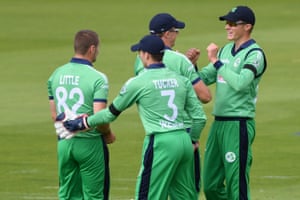 Ireland’s Harry Tector (R) is congratulated by teammates after taking the catch to dismiss England’s Eoin Morgan off the bowling of Ireland’s Josh Little (L) for 106.