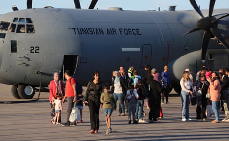 Tunisian citizens evacuated from Sudan disembark from a military aircraft at Tunis-Carthage.
