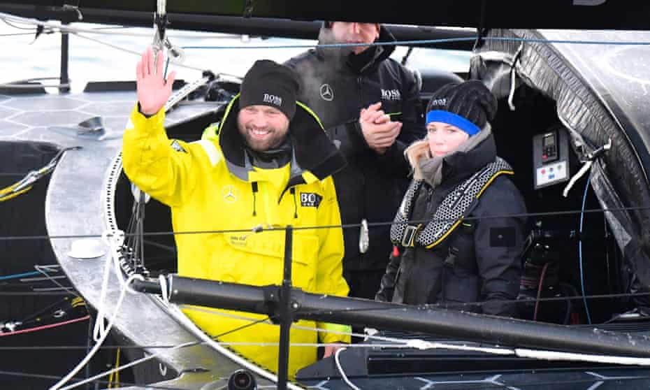 Alex Thomson celebrates with his wife Kate aboard his Imoca monohull Hugo Boss after crossing the finish line of the Vendee Globea round-the-world yacht race, off Les Sables d’Olonne, western France