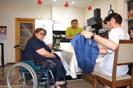 Mahammad Kekalov, right, with Zinyet Veliyeva and her husband, Galib Aliyev, in their Baku apartment.