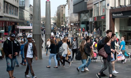 Shoppers including young people in crowded high street in centre of Birmingham