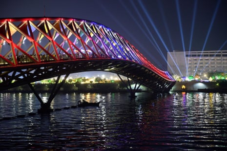 Visitors throng the illuminated Atal Pedestrian Bridge over Sabarmati river in Ahmedabad in India.