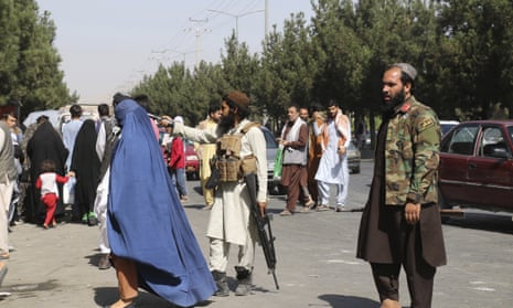Taliban fighters stand guard outside the airport after Thursday’s deadly attacks in Kabul