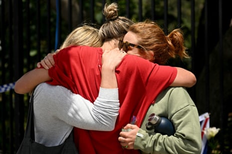 Members of the local community embrace at the Bondi Pavillion in memory of the victims