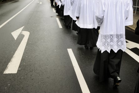 People in religious gowns walking in a line