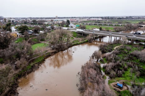 The Tuolumne River is near the top of its banks as it flows under highway 99 as it flows near Modesto, California, on 11 January.