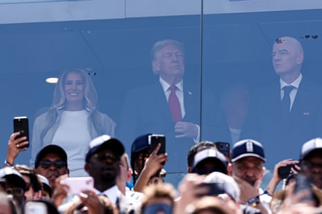 Melania Trump, Donald Trump and Gianni Infantino watch from their position in the stands.