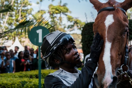 Jockey Michael Fundi pats race horse Bedford.