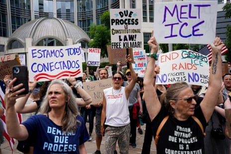 People hold placards as they gather for the arraignment and detention hearing for Kilmar Abrego Garcia in Nashville, Tennessee.