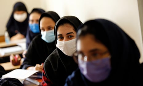 Iranian high school girls wearing face masks attend a class at the Bamdad Parsi private school during the first day of reopening schools, north of Tehran, Iran, 05 September 2020.