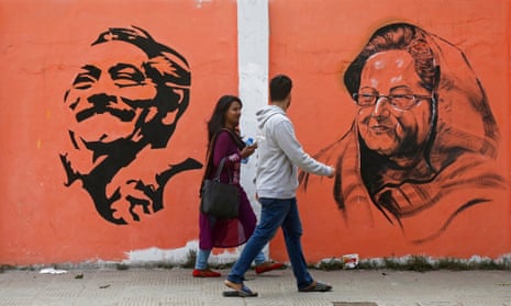 Dhaka residents stroll past a mural of Bangladesh’s assassinated founder, Sheikh Mujibur Rahman, and his daughter, Sheikh Hasina, the current prime minister.