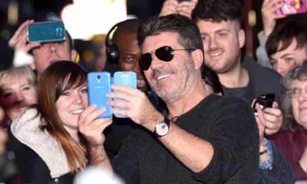 Simon Cowell takes a picture with fans at auditions for Britain’s Got Talent in Birmingham.