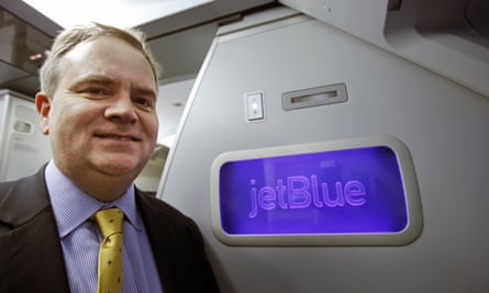 Robin Hayes, JetBlue’s chief executive on a plane with JetBlue's logo behind him