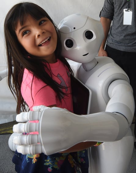 Yaretzi Bernal, 6, with Pepper, the emotional robot from Japan