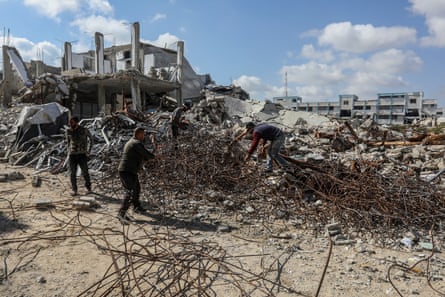 Men work amid the rubble of a building