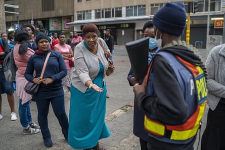 A woman pleads with a police officer