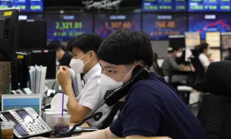 A currency trader watches monitors at the foreign exchange dealing room of the KEB Hana Bank headquarters in Seoul today