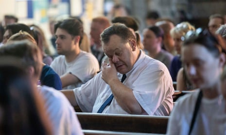 Mourners gather at St. Peters Church in Nottingham city centre for a vigil and to lay flowers and light candles for the people killed in the attack