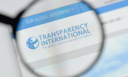 Transparency International's logo under a magnifying glass