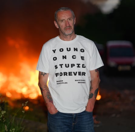 Steve Kirby in front of a bonfire.