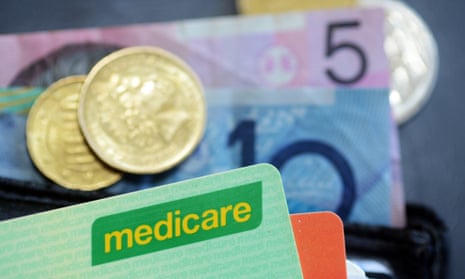 Medicare card in a wallet on top of 10 and five dollar notes