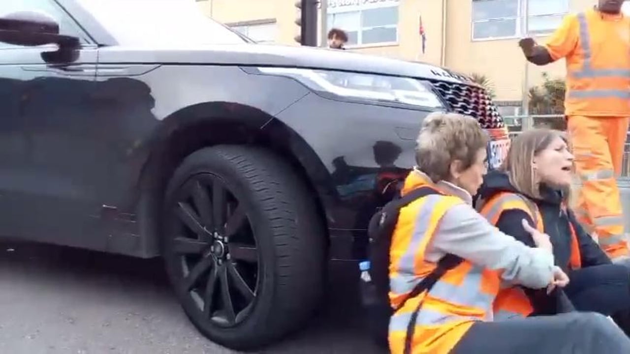 Footage shows moment Insulate Britain protester was pushed by wheels of car Footage shows moment Insulate Britain protester was pushed by wheels of car
