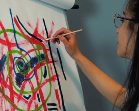 A woman drawing on a flip chart