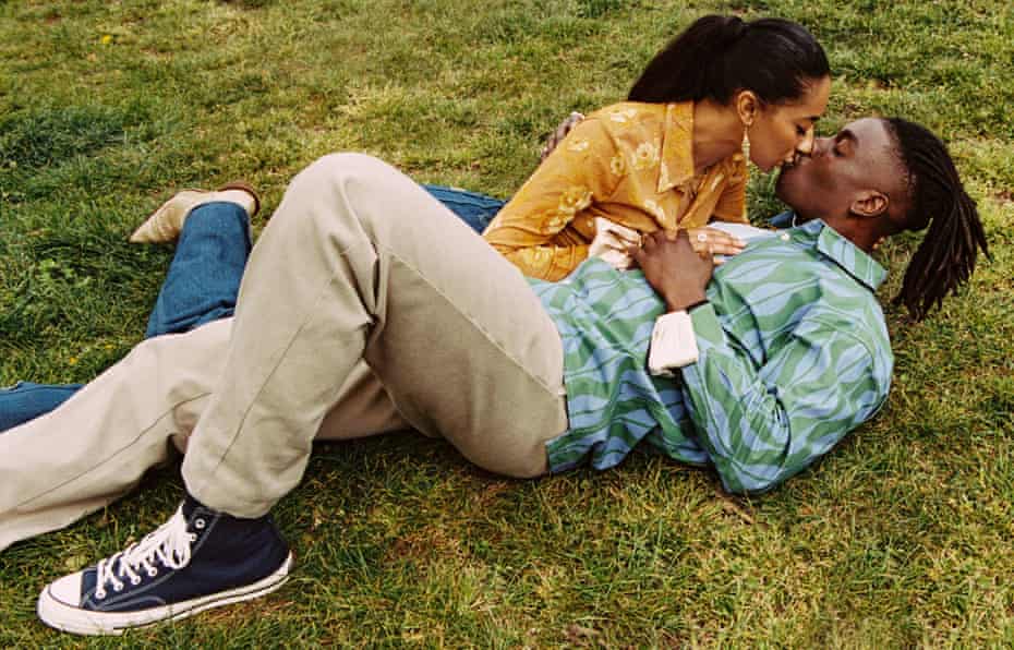 Sean Cole (28) and Sophia Alonge (27) lying on the grass and kissing, May 2021